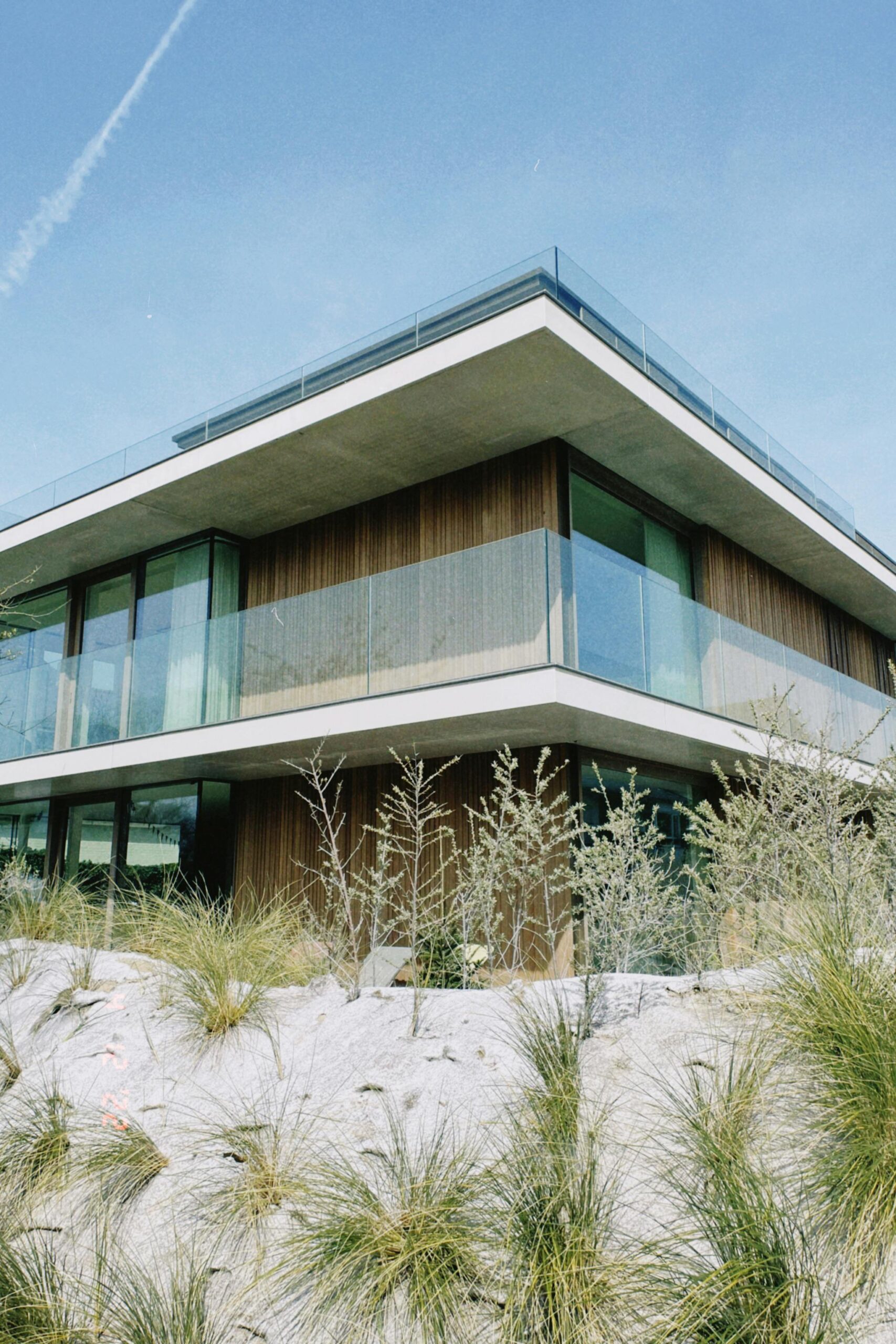 Nos biens Contemporary villa featuring glass balconies and unique desert-inspired landscaping.