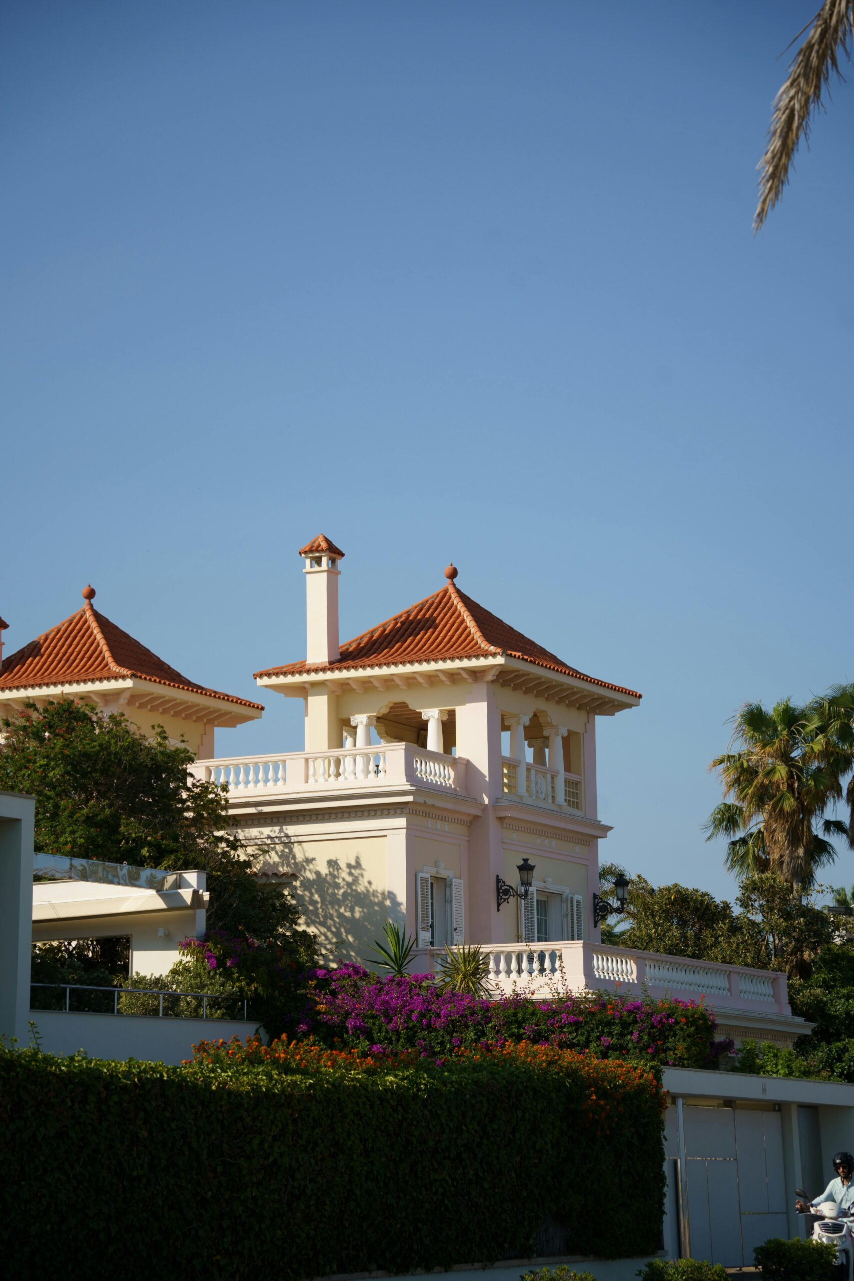 Nos biens Stunning villa in Sitges, Spain featuring Mediterranean architecture and a vibrant garden.